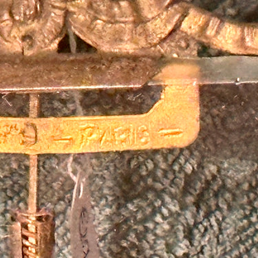 Picture frame/photo frame marked with Paris - with a bow at the top and thick glass with a ground edge - fairly weathered metals, brass?, standard with ball feet and bow.