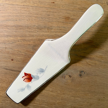 Taartschep - ongemerkt - décor met grijs/witte bladeren en een rood/paarse bloem