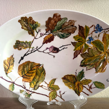 Bowl / Plate - oval, flat, model - Petrus Regout - design with (self-applied) oak leaves - original is cream/white