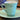 Tasse und Untertasse - ungemarkt - grün mit goldfarbenen Sternen und einer goldfarbenen Linie in der Tasse